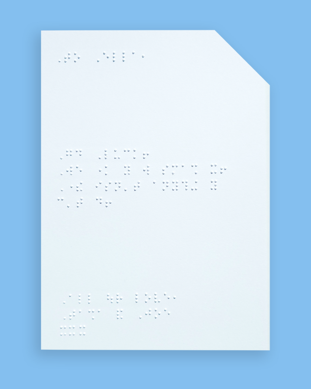 Pale blue background with an example of a braille message inside the card.