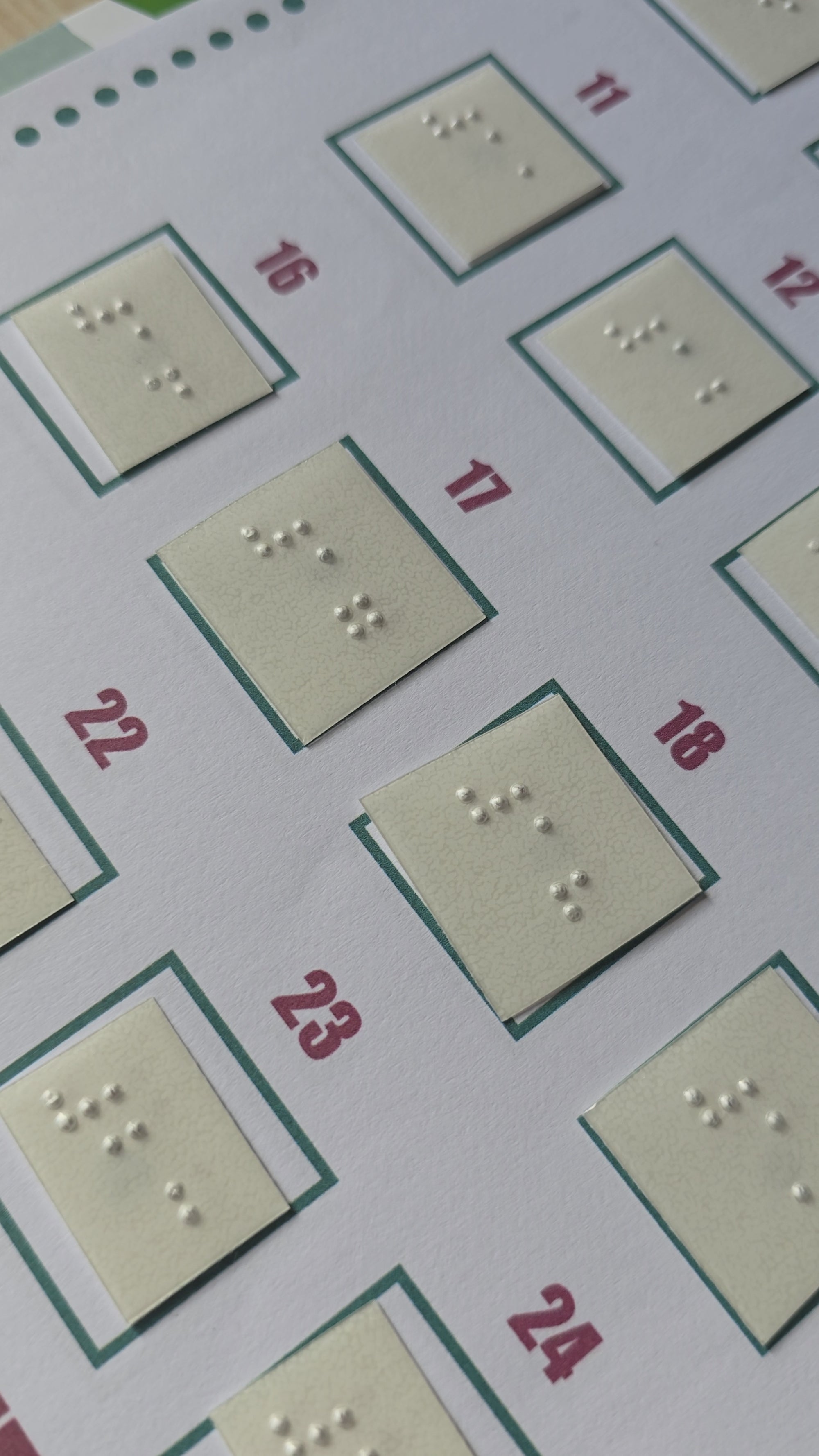 Video shows the braille numbers stuck to the printed document. It pans over the document, close-up. 