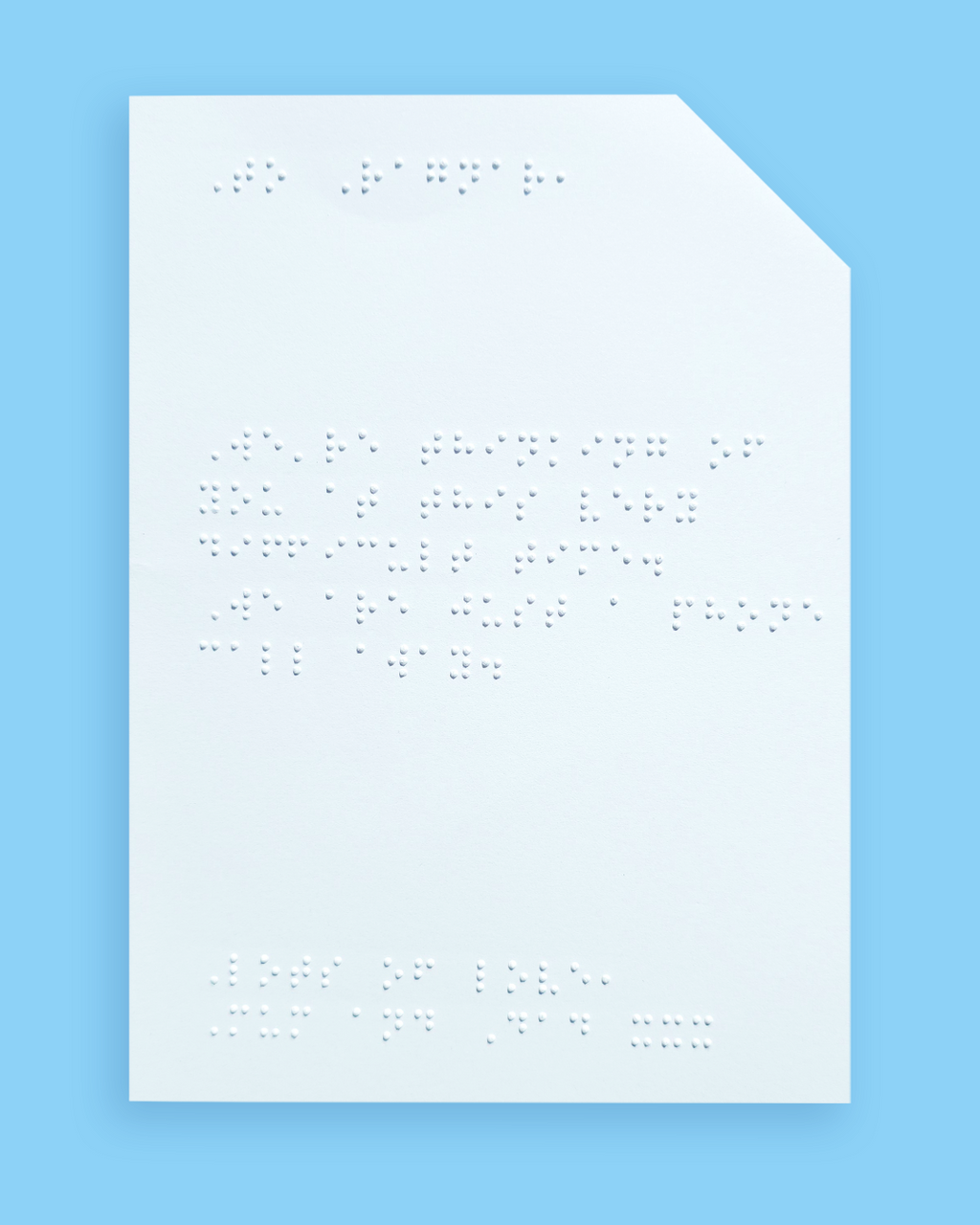 Pale blue background with an example of a braille message inside the card.